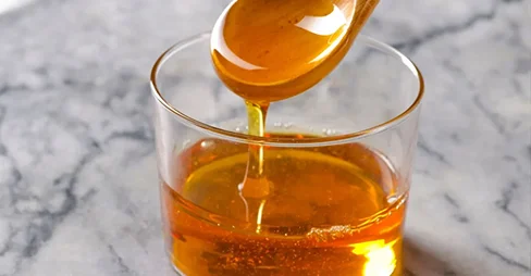 Agave syrup pouring on a glass