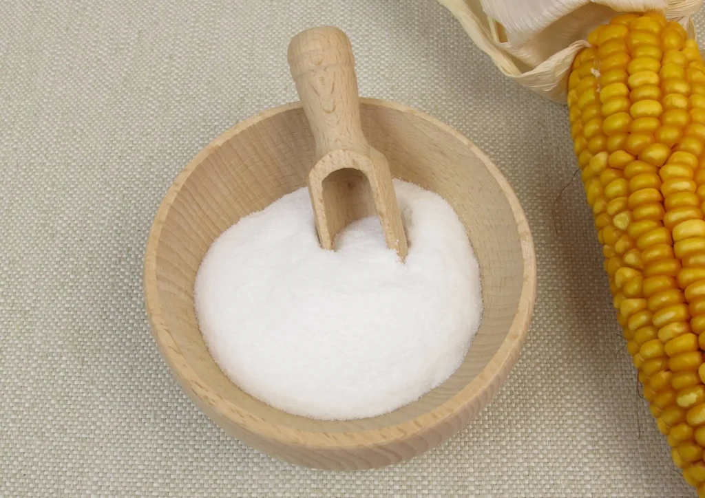 powder on the table with wooden spoon and corn