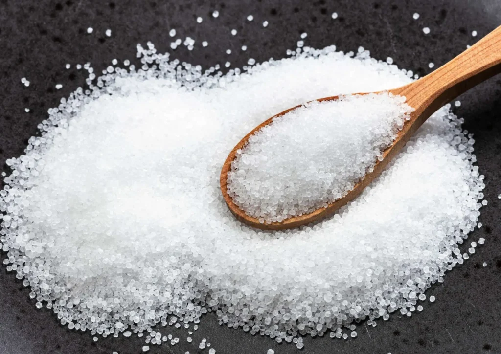 sugar on the table with wooden spoon
