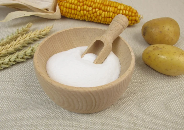 powder on the table with wooden spoon and corn
