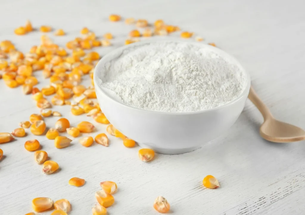 powder on the table with wooden spoon and corn