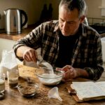 Brewer measuring brewing sugars at kitchen table
