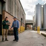 Plant manager and driver at sugar refinery loading bay